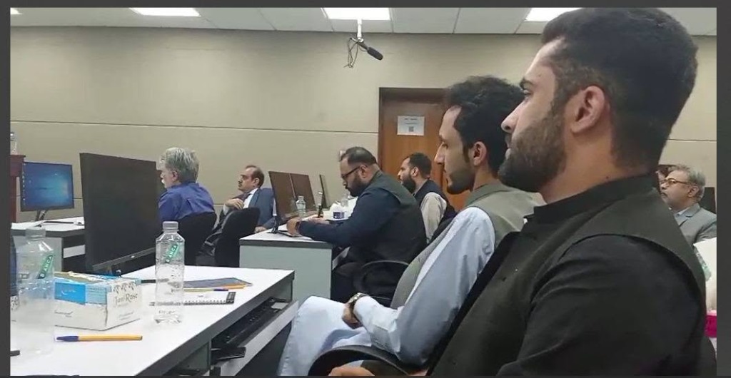 Bilal Ahmad and workshop participants collaborating at computers at the Nerithonx event